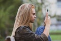 Teen girl, park bench, internet browsing Royalty Free Stock Photo