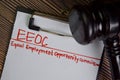 EEOC - Equal Employment Opportunity Commission write on a paperwork isolated on Wooden Table