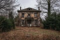 An eerie and dilapidated old house amidst an empty field, reflecting years of neglect and abandonment, An abandoned haunted house Royalty Free Stock Photo