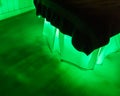 Eerie green glow under a bed