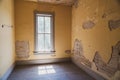 Eerie interior room in an abandoned home in Bannack Ghost Town Montana, with peeling paint, exposed walls and an old window Royalty Free Stock Photo