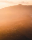 Eerie scenery of misty mountains at sunset