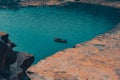 Eerie scenery of people on an old wooden shallop on the blue waters of a lake Royalty Free Stock Photo