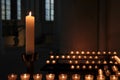 Eerie shot of candles on candle holders lighted on a dark room perfect for horror scenes Royalty Free Stock Photo