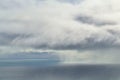 Eerie view of heavy rain shaft drops from clouds at sea