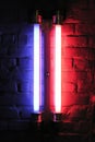 An effect of red and blue neon lighting on a brick wall that is not plastered. Royalty Free Stock Photo