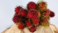 The effect of the red rambutan on the market with a white background.