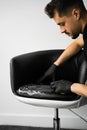 Effective brush cleaning with detergent of leather furniture at home. Dry cleaning. Cleaning is washing leather chair