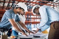 Effective collaboration makes for quick turnaround time. a group of builders having a meeting at a construction site.