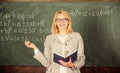 Effective teaching involve acquiring relevant knowledge. Woman teaching near chalkboard in classroom. Effective teaching Royalty Free Stock Photo