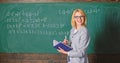 Effective teaching involve acquiring relevant knowledge. Woman teaching near chalkboard in classroom. Qualities that Royalty Free Stock Photo