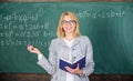 Effective teaching involve acquiring relevant knowledge. Woman teaching near chalkboard in classroom. Effective teaching Royalty Free Stock Photo