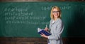 Effective teaching involve acquiring relevant knowledge. Woman teaching near chalkboard in classroom. Qualities that Royalty Free Stock Photo