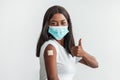Lady In Mask Showing Shoulder With Patch And Thumbs Up Royalty Free Stock Photo
