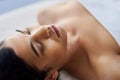 When the effects of a luxurious spa experience lingers. an attractive young woman relaxing on a massage table at a spa.