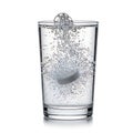 Effervescent tablet dissolving in a glass of water Royalty Free Stock Photo