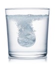 Effervescent tablet dissolving in a glass of water. Clipping path