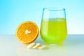 Effervescent vitamin C pill dissolves in water. Royalty Free Stock Photo