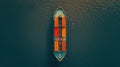 Efficient aerial view of container cargo ship navigating the sea under clear skies. Royalty Free Stock Photo