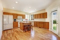 Efficient, compact kitchen design with honey stained kitchen cabinets Royalty Free Stock Photo