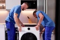 Efficient Delivery and Professional Installation of Washing Machine: Including Carry, Repair Royalty Free Stock Photo