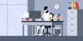 Efficient humanoid AI robot sitting at the office desk and working