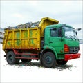 Efficient waste removal Garbage trucks in action, emptying containers isolated