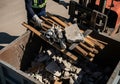 Efficient worker loading construction debris into container for removal Royalty Free Stock Photo