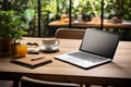 Efficient workspace with laptop, coffee, notebook, houseplant on wooden table