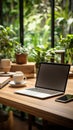 Efficient workspace with laptop, coffee, notebook, houseplant on wooden table