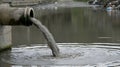 Effluent pipe discharging sewage into a river causing water pollution problem Royalty Free Stock Photo
