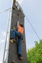 Effort of a boy in climbing a wall Royalty Free Stock Photo
