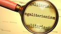 Egalitarianism and a magnifying glass on word Egalitarianism to symbolize studying and searching for answers related to a concept Royalty Free Stock Photo