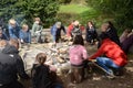 Families around a campfire make breads on sticks