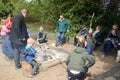 Families around a campfire make breads on sticks