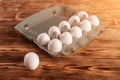 Egg on a background of egg packaging on a wooden table in sunlight Royalty Free Stock Photo