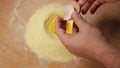 The egg is beaten into the semolina