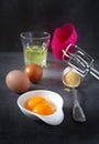 Egg beater, eggs and silicone baking dish Royalty Free Stock Photo