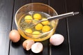 Egg beater on a glass bowl with eggs Royalty Free Stock Photo