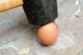 Egg being smashed or cracked with a hammer Royalty Free Stock Photo