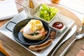 Egg benedict with bacon and sausage - delicious american breakfast Royalty Free Stock Photo