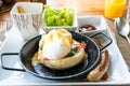 Egg benedict with bacon and sausage - delicious american breakfast