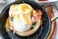 Egg benedict with bacon and sausage - delicious american breakfast Royalty Free Stock Photo