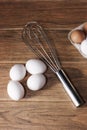 White and beige eggs with a hand stainless steel mixer