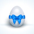 Egg with blue ribbon bow isolated on white Royalty Free Stock Photo