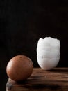 Egg and broken eggshell on wooden background. Close Up, Vertical orientation. Copy space Royalty Free Stock Photo