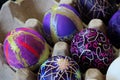 An egg carton holding decorated easter eggs Royalty Free Stock Photo