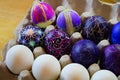 An egg carton holding decorated easter eggs Royalty Free Stock Photo