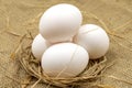 Egg carton on jute fabric. close-up white egg