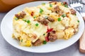 Egg casserole with potatoes, sausage and pepper, on white plate